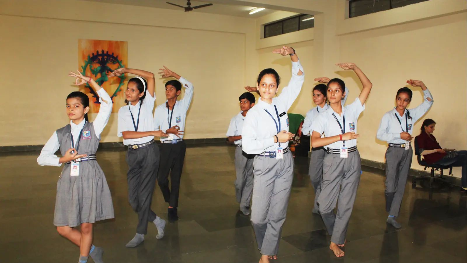 Students performing a dance routine on stage at a school event
